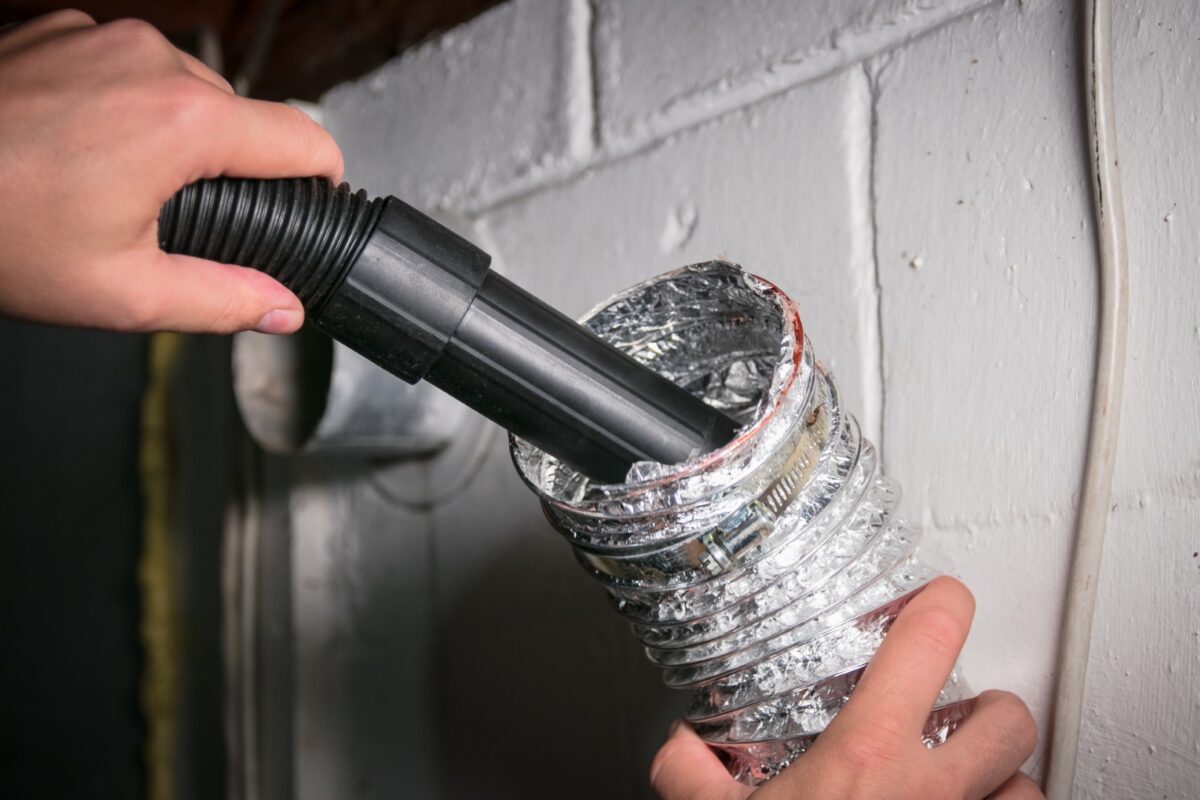Picture of a dryer vent getting cleaned