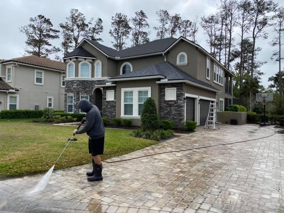 Picture of a driveway getting pressure washed